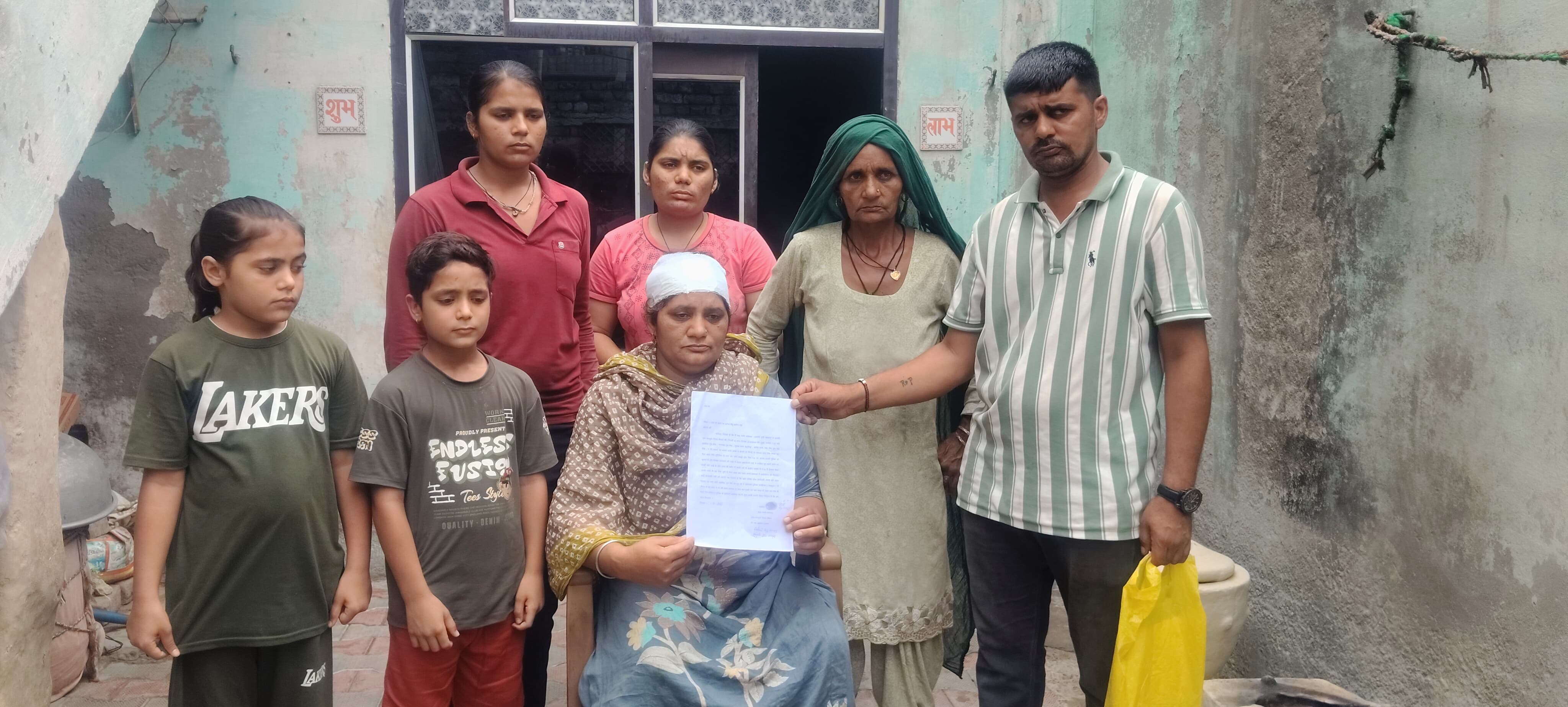 गांव शिमला में परिवार के सदस्यों के साथ जानकारी देती पीडि़त महिला रेखा